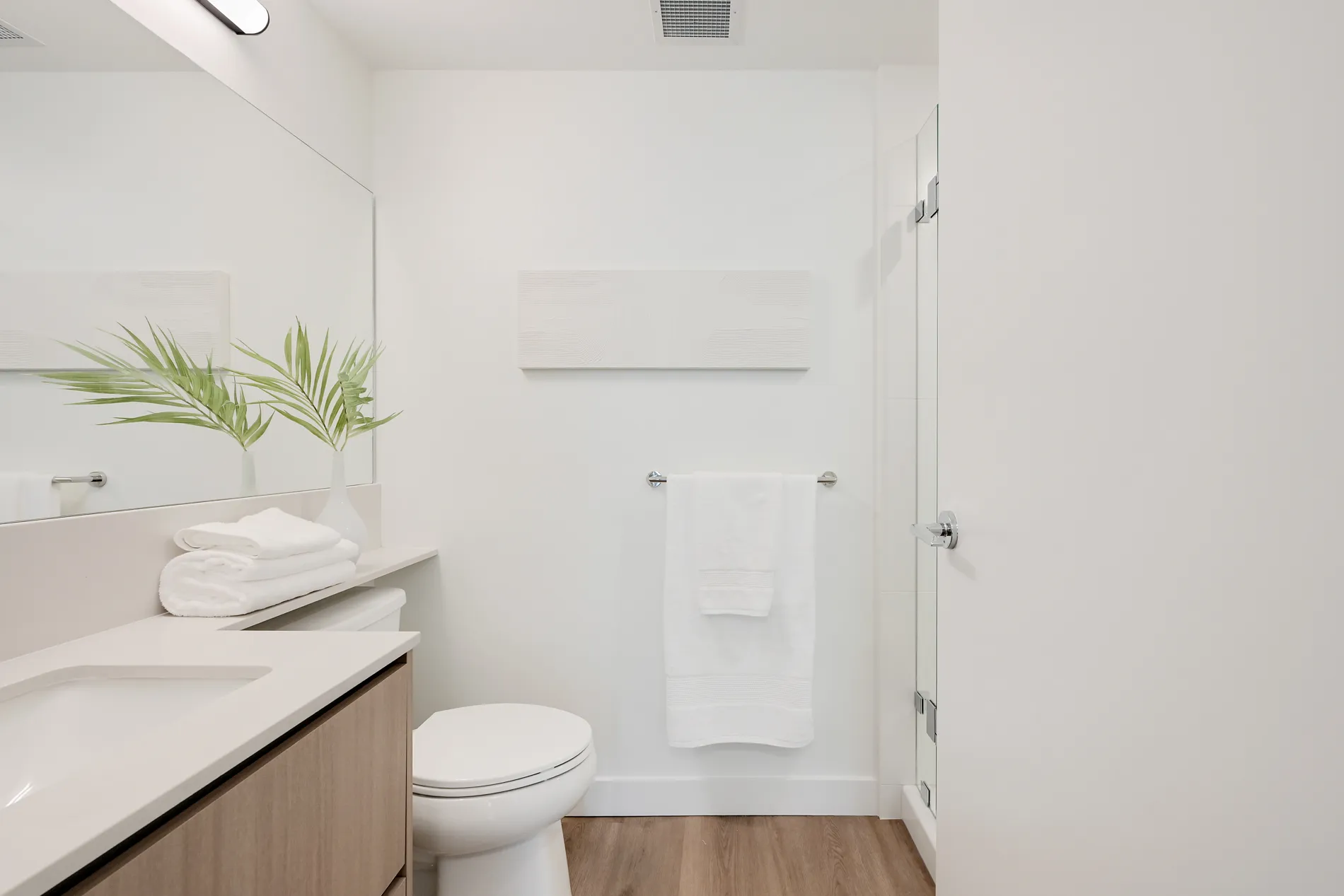 Modern bathroom with vanity, towel rack, and standing shower in this 2-bedroom rental home at Spencer Block