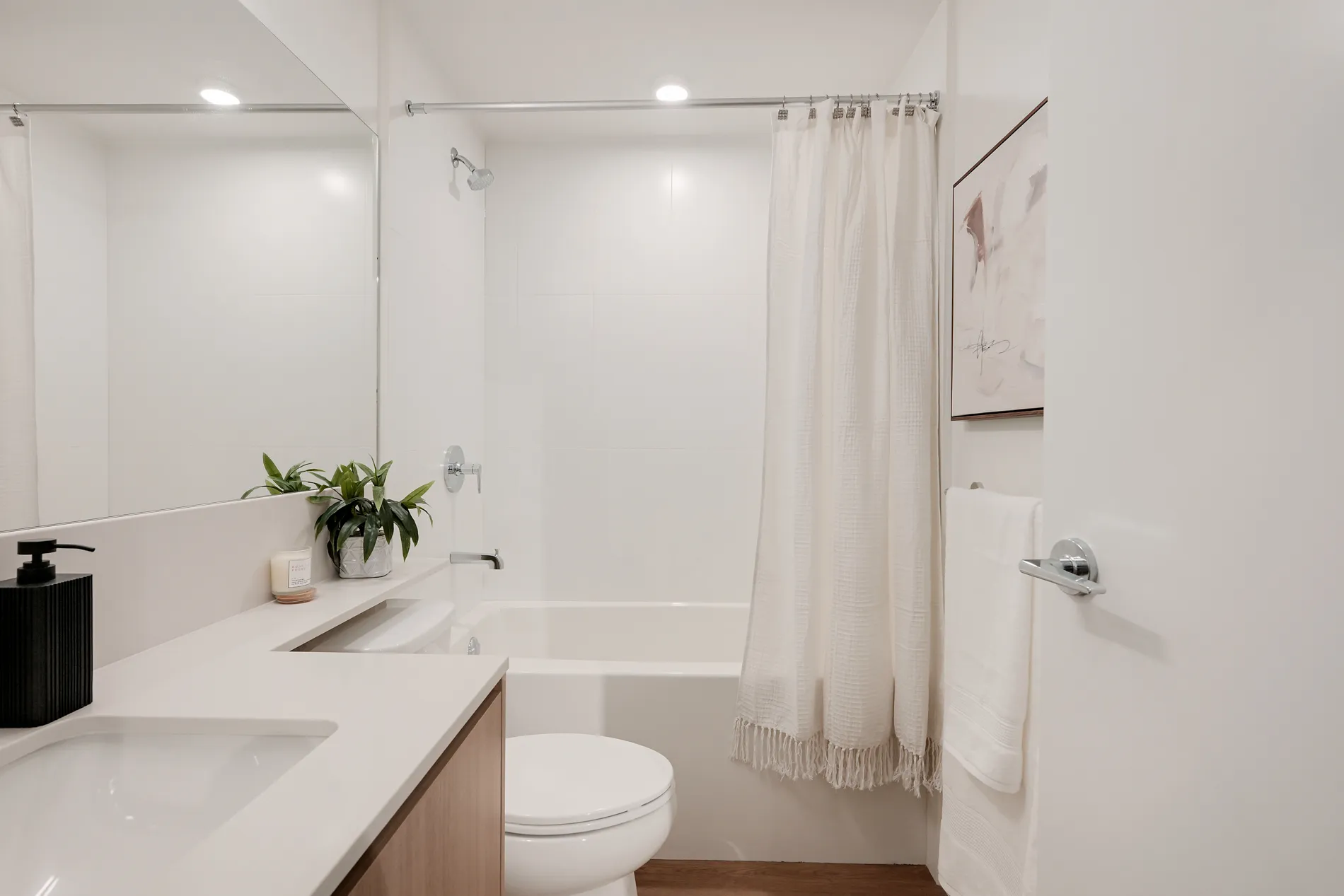 Modern bathroom with vanity, tub and shower in this 2-bedroom rental home at Spencer Block