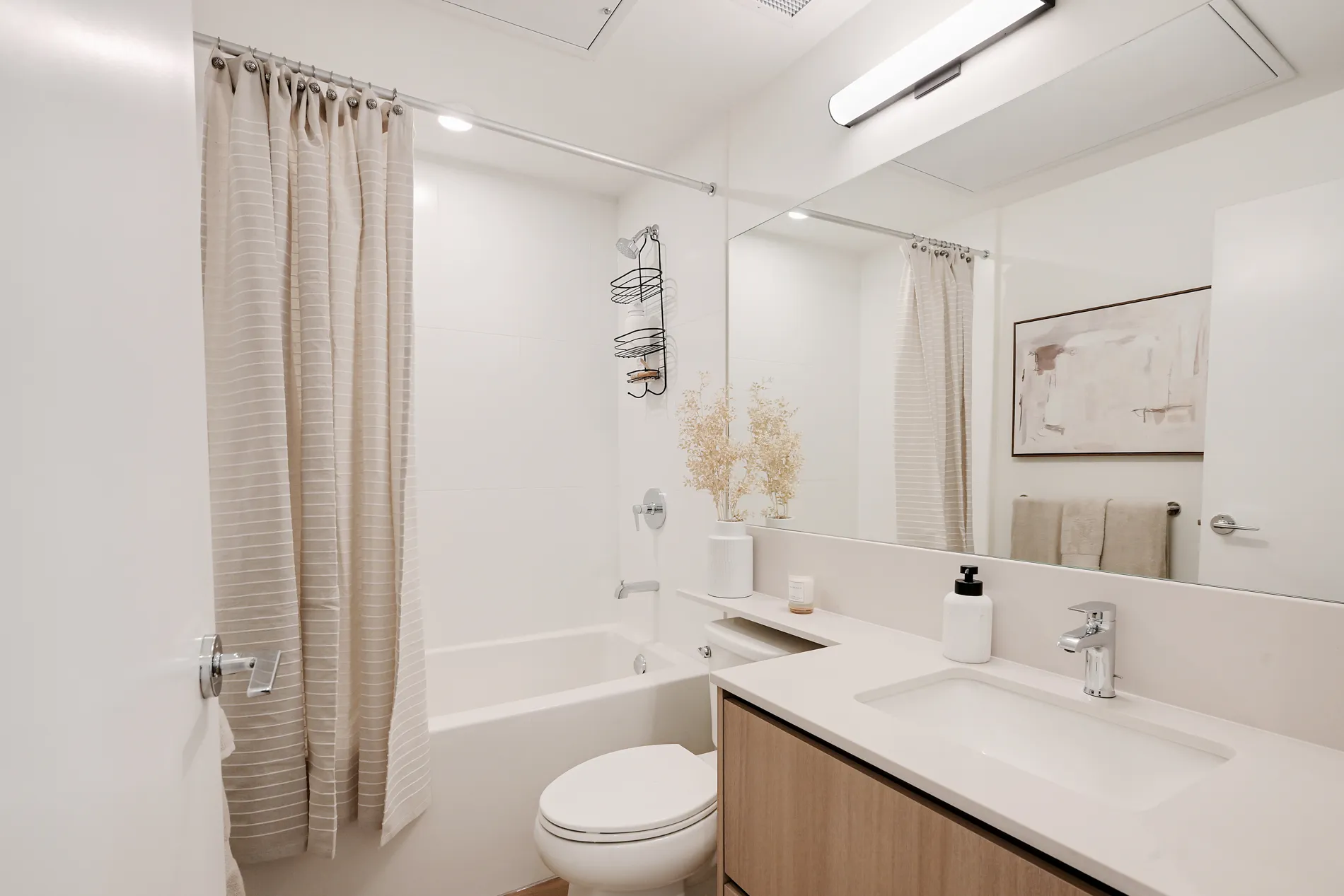 Spencer Block rental home bathroom with modern vanity, bathtub, and shower
