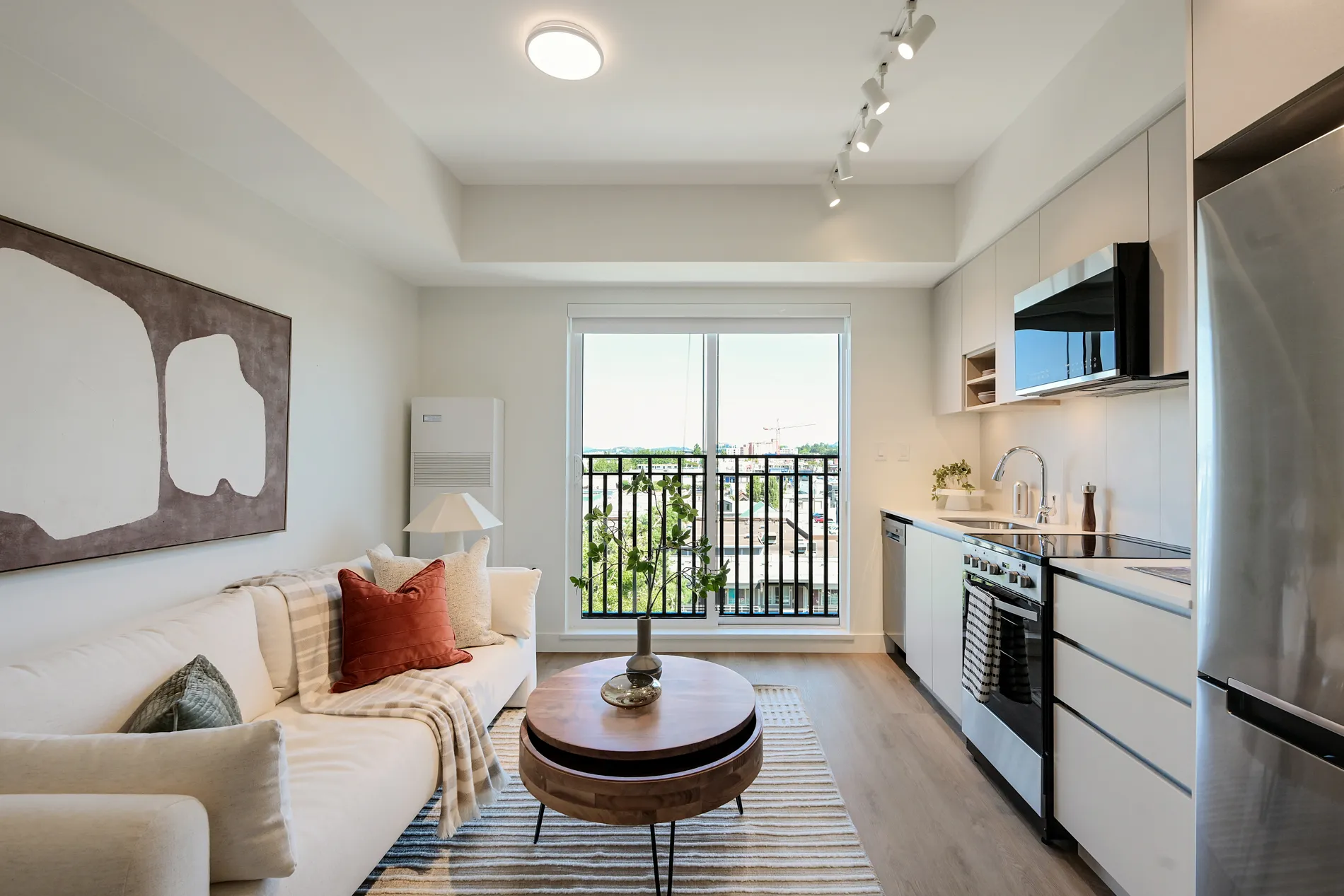 Bright rental home at Spencer Block with a kitchen, living area, and juliette balcony