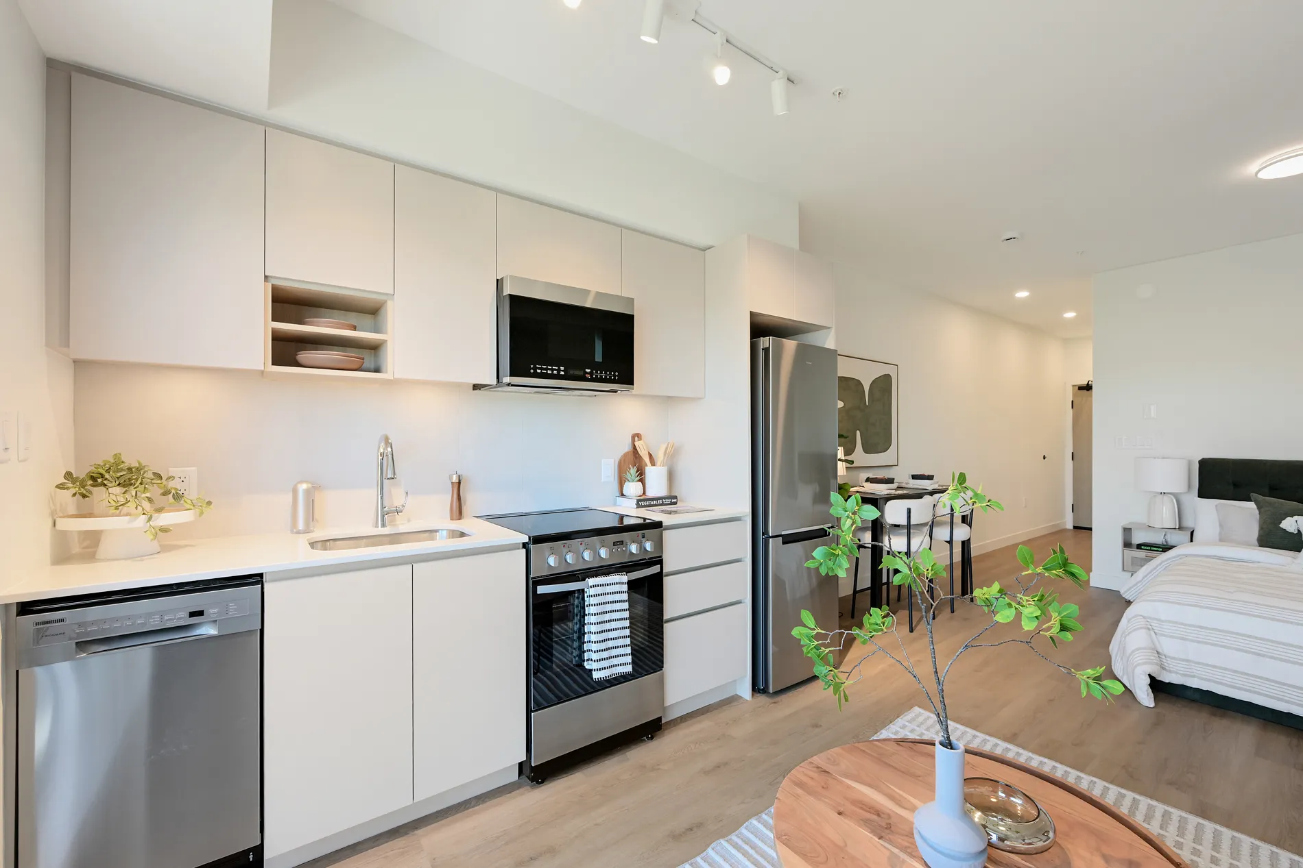 Rental home at Spencer Block with modern kitchen, white cabinetry, stainless steel appliances