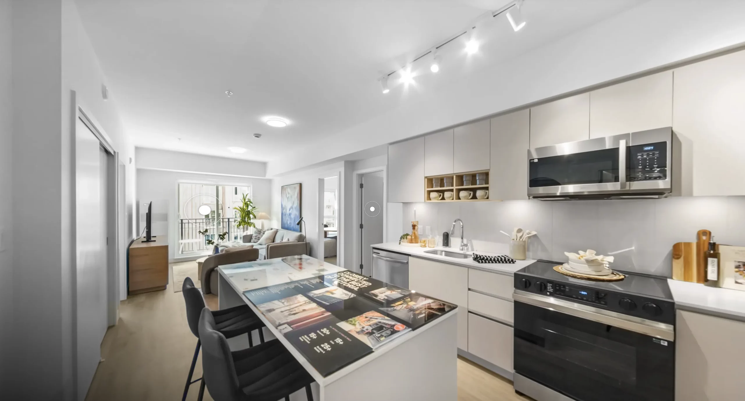 Bright kitchen and living area in a Spencer Block rental home, with a central island and dining seating