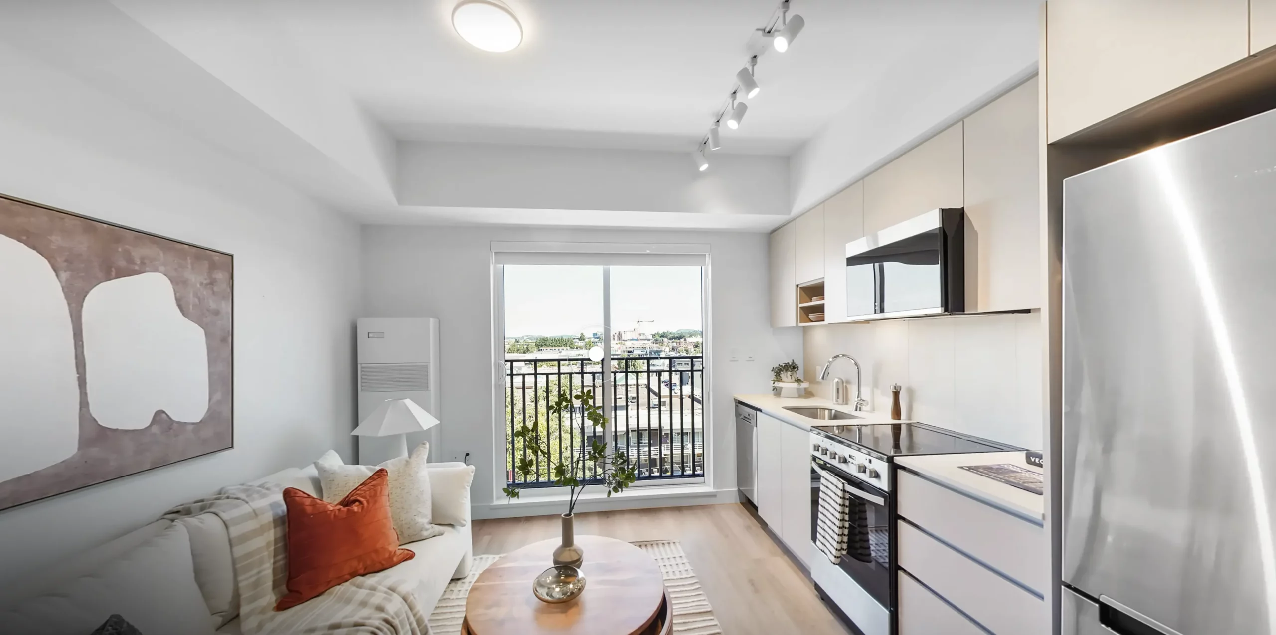 Bright kitchen and living area in a Spencer Block studio rental home, with a juliette balcony
